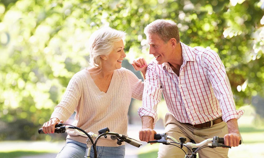 Elderly couple riding bikes