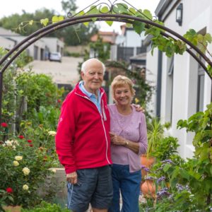 Retired couple standing outside their life rights home