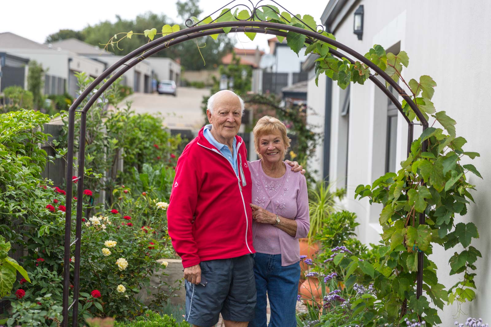 Retired couple standing outside their life rights home