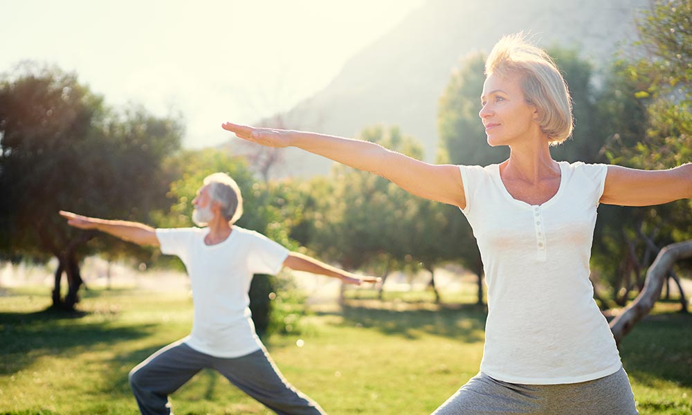 Retired couple doing yoga