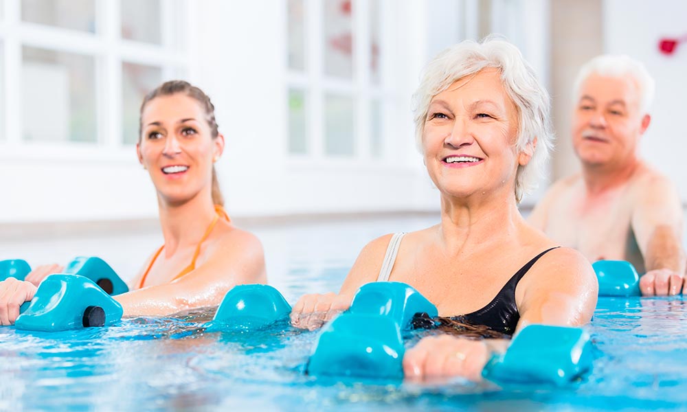 80yr old woman exercising in pool