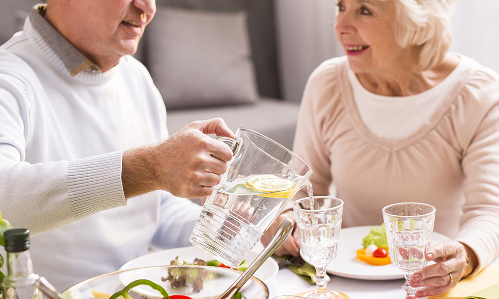 Retired couple eating chicken roulade for dinner