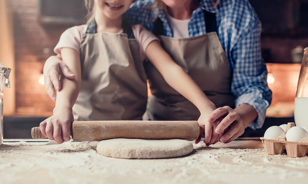 Retired grandparent baking with grandchild